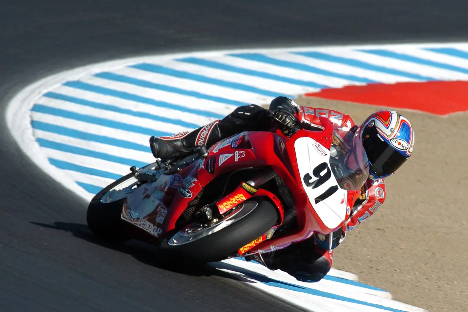 A person on a motorcycle riding around a track.