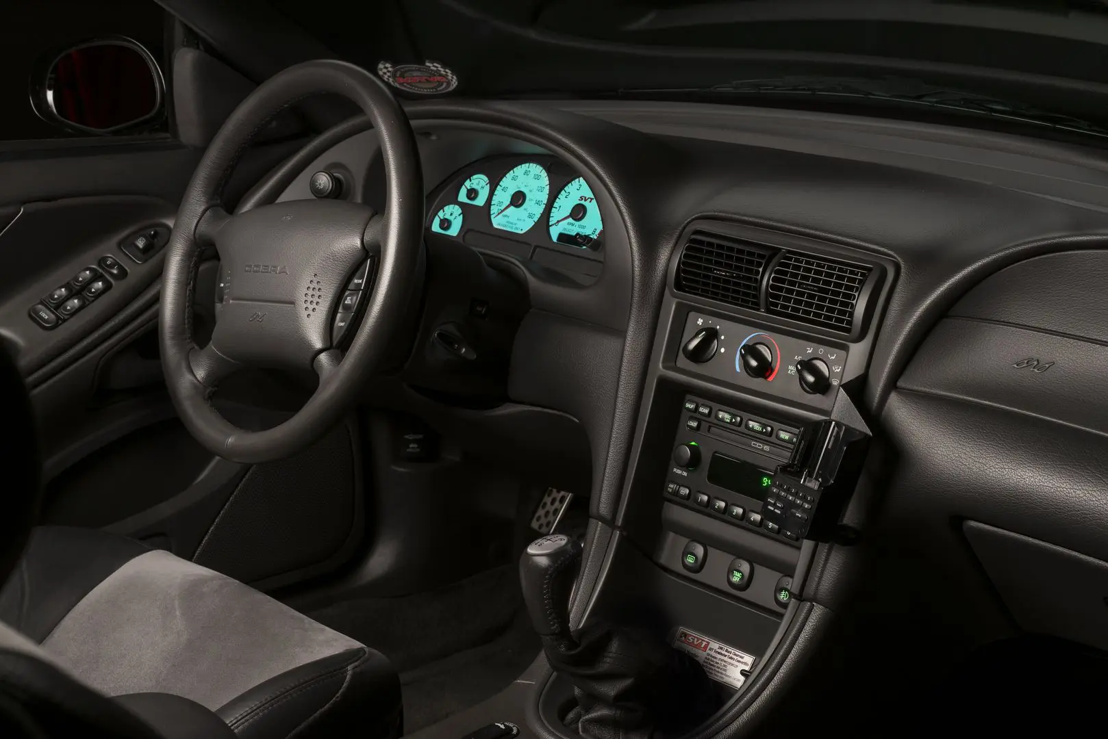 A car dashboard with the steering wheel turned on.