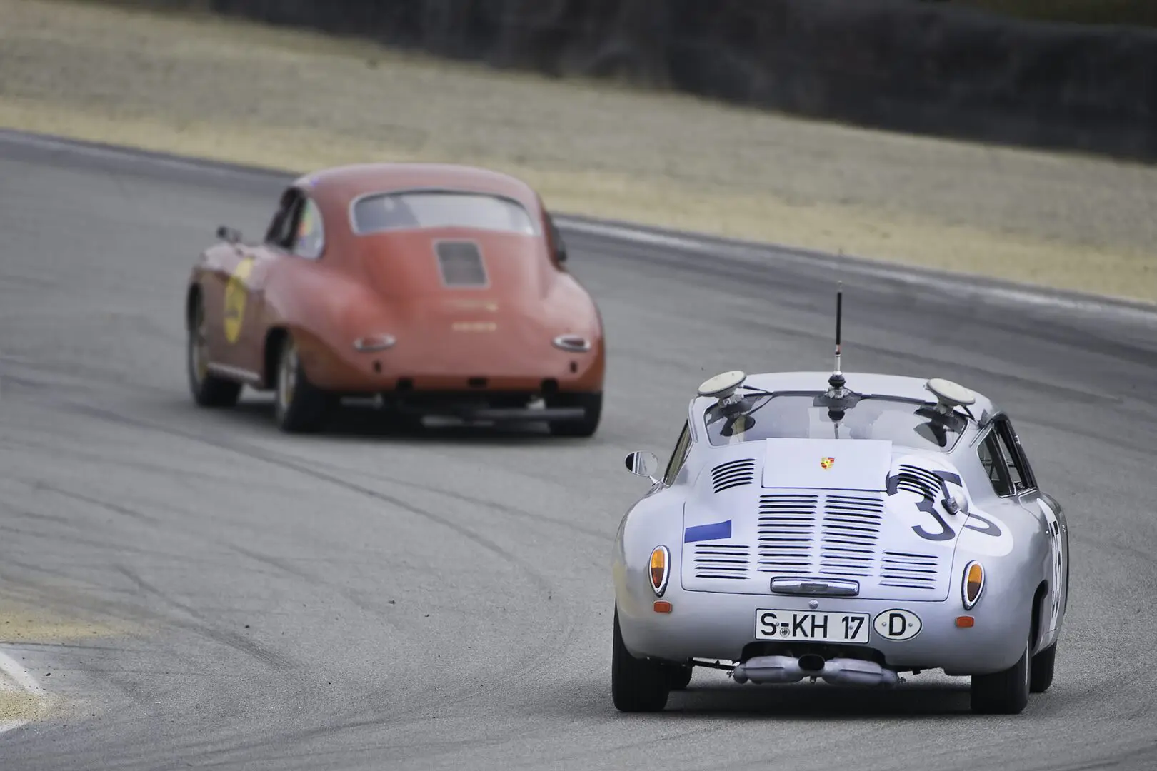 Two cars are racing on a track in the same race.